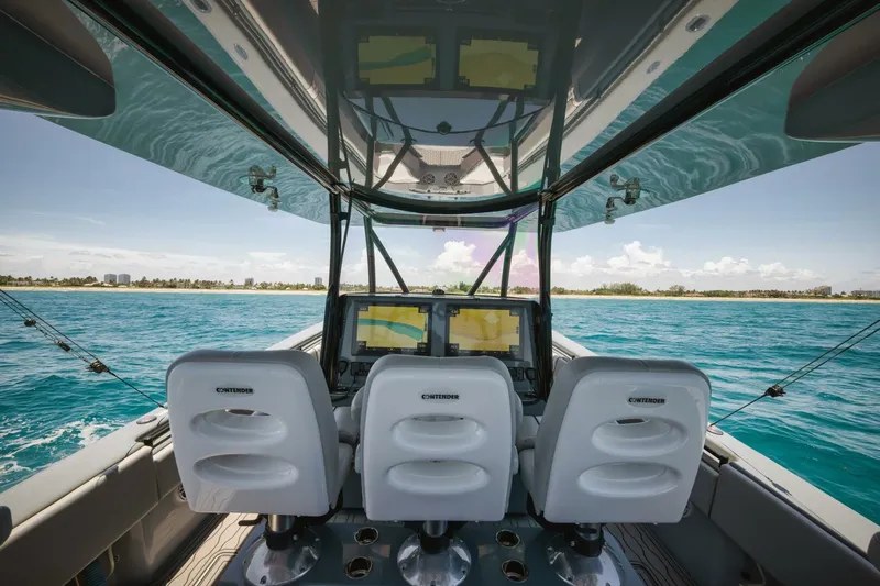 Deal Maker Yacht Photos Pics 2024 Contender 44ST boat interior with ocean view and advanced navigation system.