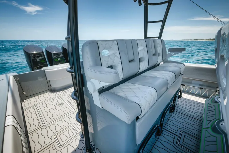Deal Maker Yacht Photos Pics 2024 Contender 44ST boat interior with cushioned seating and ocean view.
