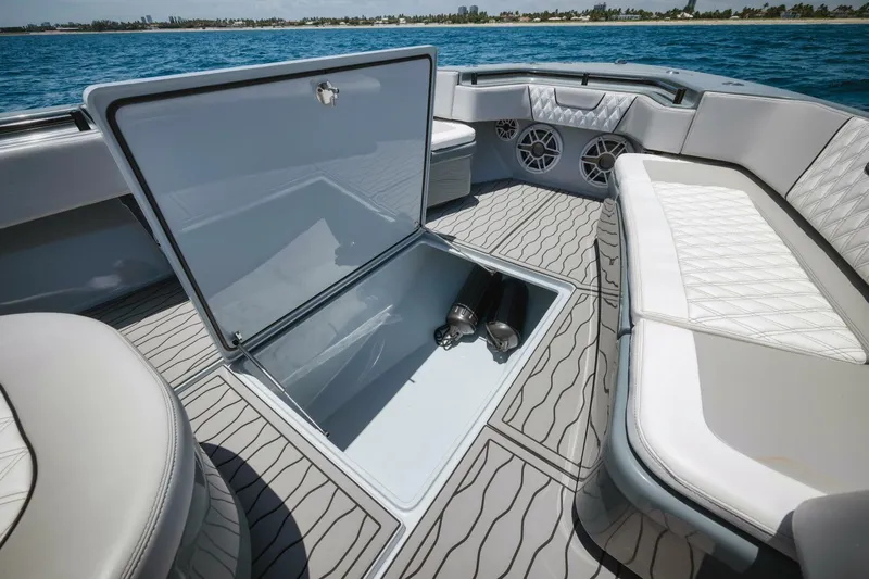 Deal Maker Yacht Photos Pics 2024 Contender 44ST boat interior with open storage compartment and cushioned seating.