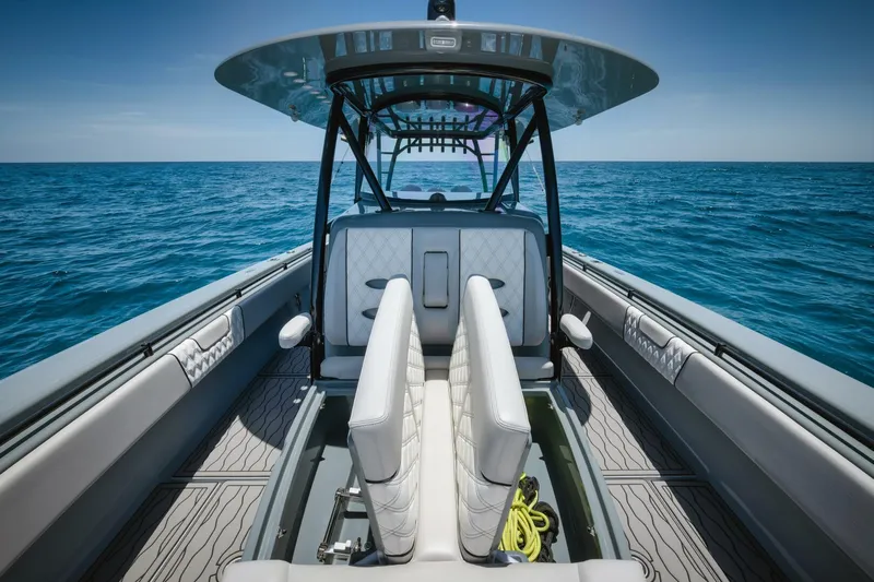 Deal Maker Yacht Photos Pics 2024 Contender 44ST boat interior with dual seats and ocean backdrop.