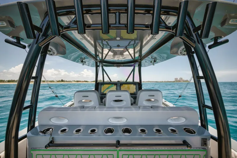 Deal Maker Yacht Photos Pics 2024 Contender 44ST boat interior with fishing rod holders and ocean view.