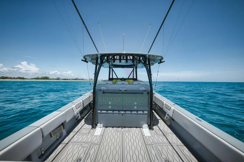 Deal Maker Yacht Photos Pics 2024 Contender 44ST boat on open water with clear blue sky.