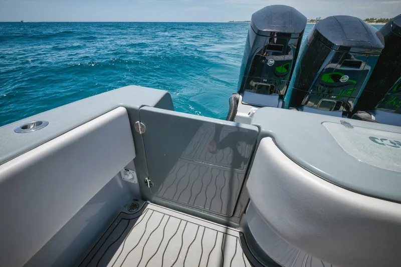 Deal Maker Yacht Photos Pics 2024 Contender 44ST boat stern with triple outboard engines on open water.