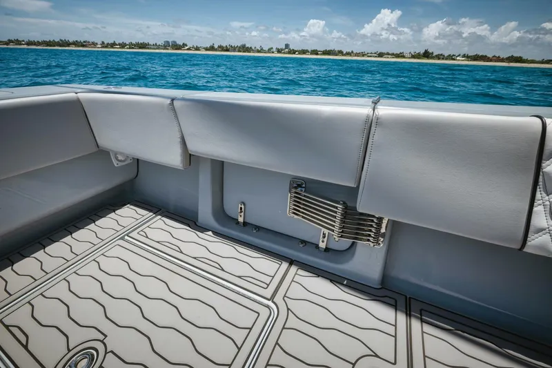 Deal Maker Yacht Photos Pics 2024 Contender 44ST boat interior with cushioned seating and ocean view.