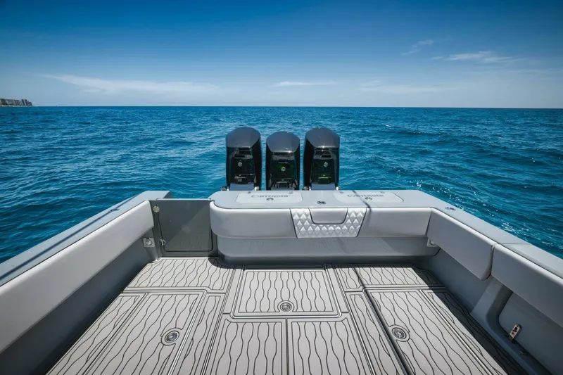 Deal Maker Yacht Photos Pics 2024 Contender 44ST boat with triple outboard engines on open sea.