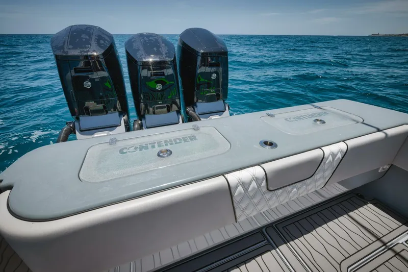 Deal Maker Yacht Photos Pics 2024 Contender 44ST boat with triple outboard engines on the ocean.