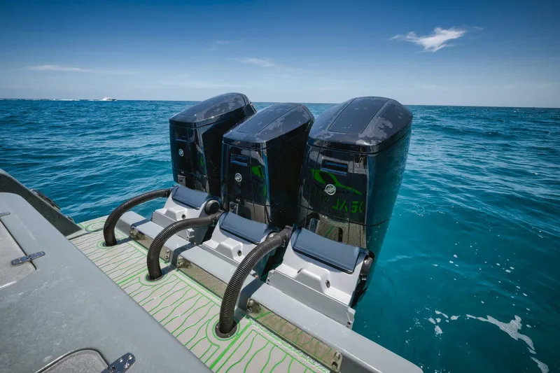 Deal Maker Yacht Photos Pics 2024 Contender 44ST boat with triple outboard engines on the ocean.