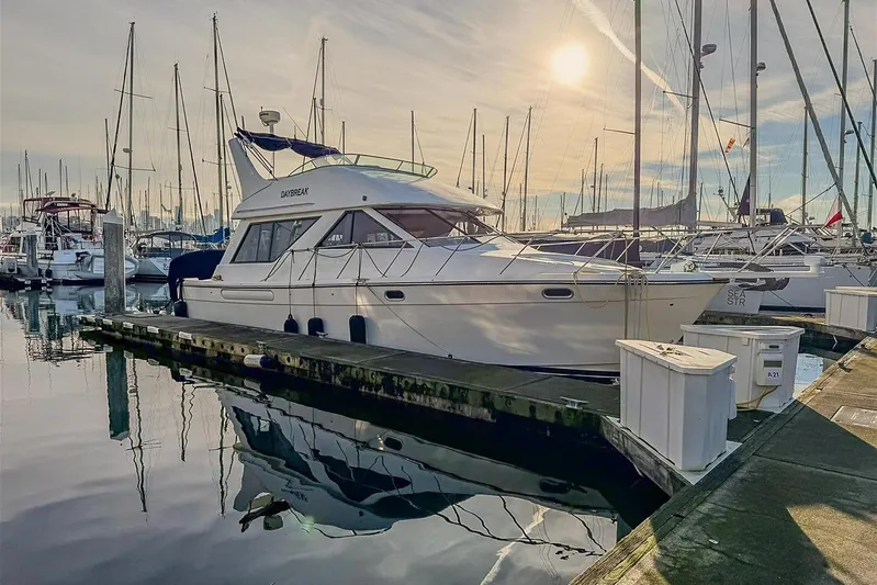 Daybreak Yacht Photos Pics 2002 Bayliner 3988 Command Bridge Motoryacht docked at marina under sunny sky.