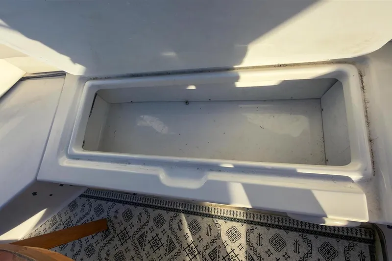 Daybreak Yacht Photos Pics Open storage compartment on 2002 Bayliner 3988 Command Bridge Motoryacht, with patterned flooring.