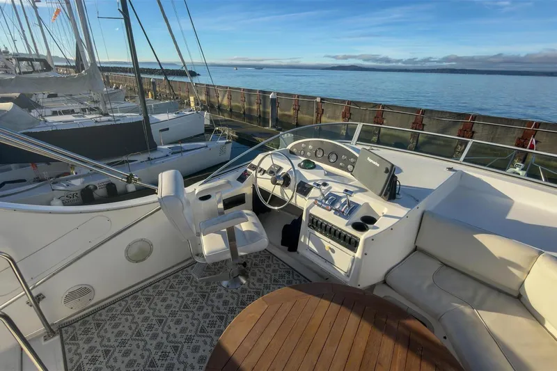 Daybreak Yacht Photos Pics 2002 Bayliner 3988 Command Bridge Motoryacht helm with ocean view and seating area.