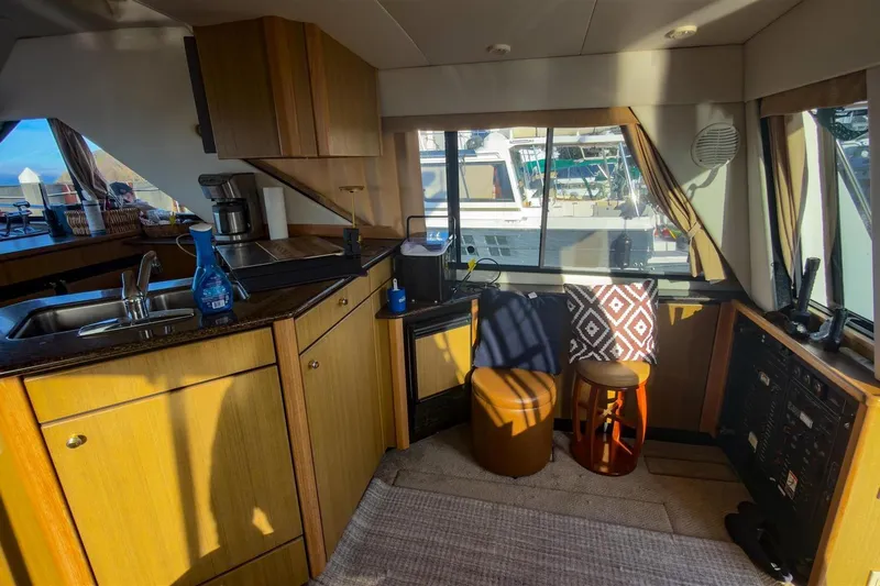 Daybreak Yacht Photos Pics Interior of 2002 Bayliner 3988 Command Bridge Motoryacht with kitchen and seating area.