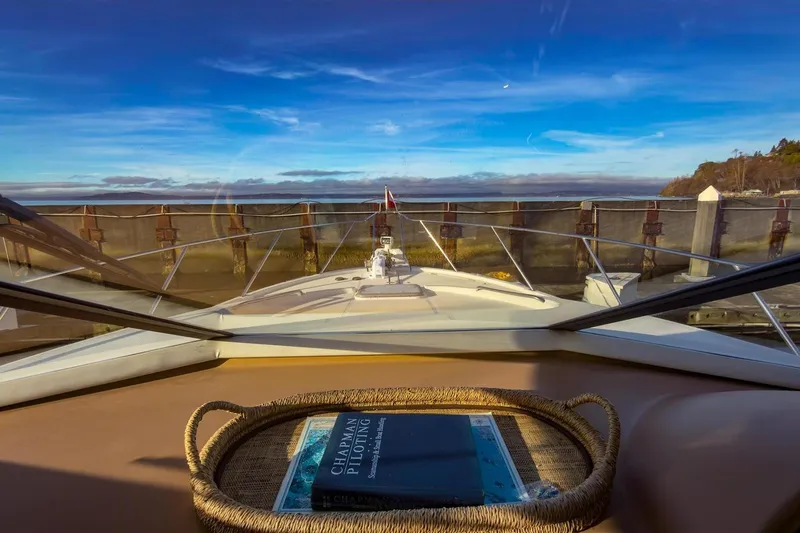 Daybreak Yacht Photos Pics 2002 Bayliner 3988 Command Bridge Motoryacht view from helm, docked with clear blue sky.