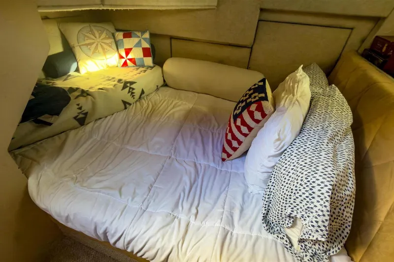 Daybreak Yacht Photos Pics Cozy cabin interior of 2002 Bayliner 3988 Command Bridge Motoryacht with nautical-themed bedding.