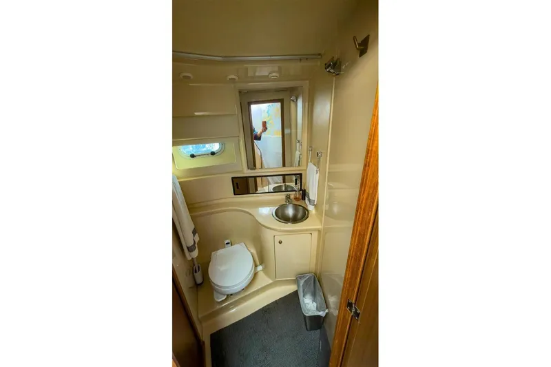 Daybreak Yacht Photos Pics 2002 Bayliner 3988 Command Bridge Motoryacht bathroom with sink, toilet, and mirror.