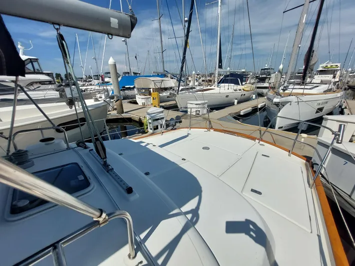 Wind & Wine Yacht Photos Pics Beneteau Oceanis 42CC 2002 sailboat docked in a marina, surrounded by other boats.