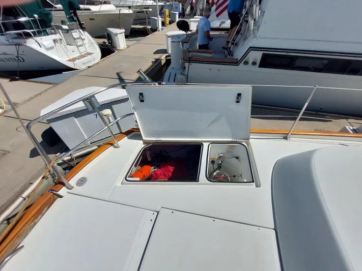 Wind & Wine Yacht Photos Pics Beneteau Oceanis 42CC 2002 yacht deck with open storage compartments at marina.