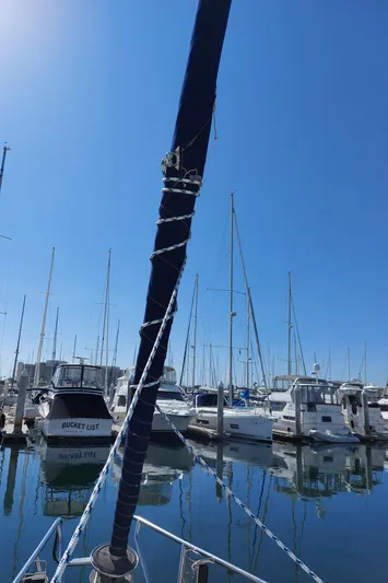 Wind & Wine Yacht Photos Pics Beneteau Oceanis 42CC sailboat docked in a marina, clear blue sky, 2002 model.