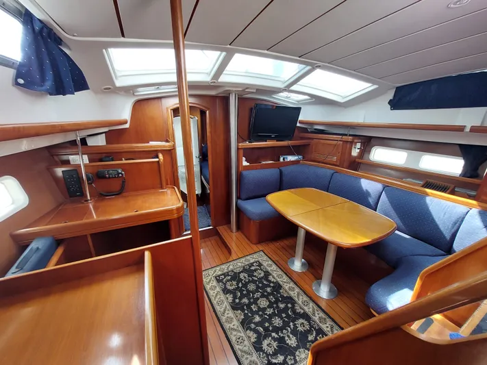 Wind & Wine Yacht Photos Pics Interior of 2002 Beneteau Oceanis 42CC sailboat with wood finish and cozy seating area.