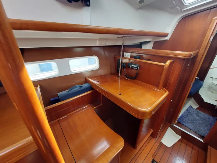 Wind & Wine Yacht Photos Pics Beneteau Oceanis 42CC 2002 yacht interior with wooden desk and seating area.