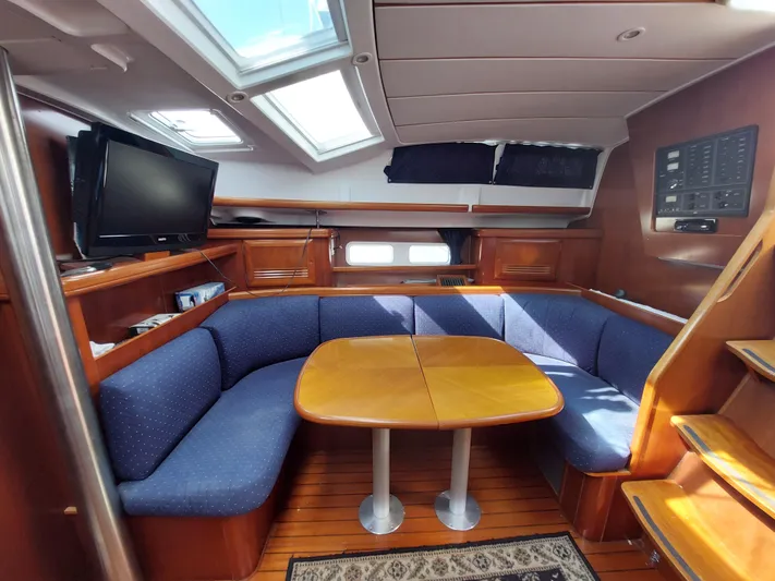 Wind & Wine Yacht Photos Pics Interior of 2002 Beneteau Oceanis 42CC yacht with cozy seating and wooden table.