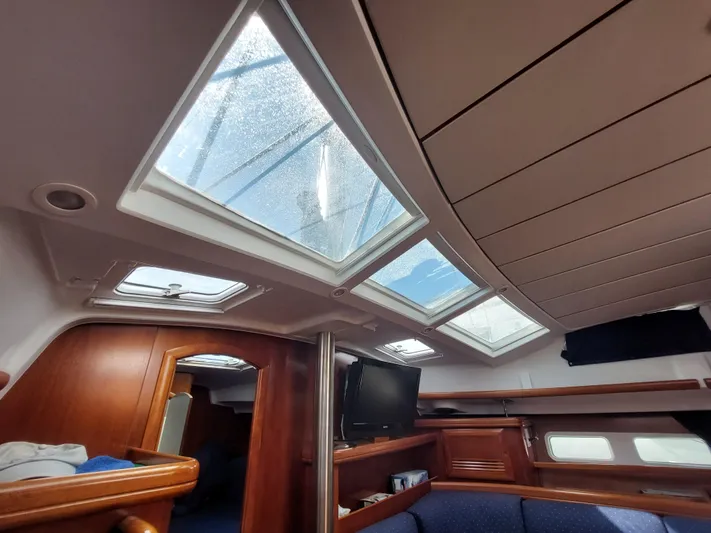 Wind & Wine Yacht Photos Pics Interior of 2002 Beneteau Oceanis 42CC sailboat with skylights and wooden furnishings.