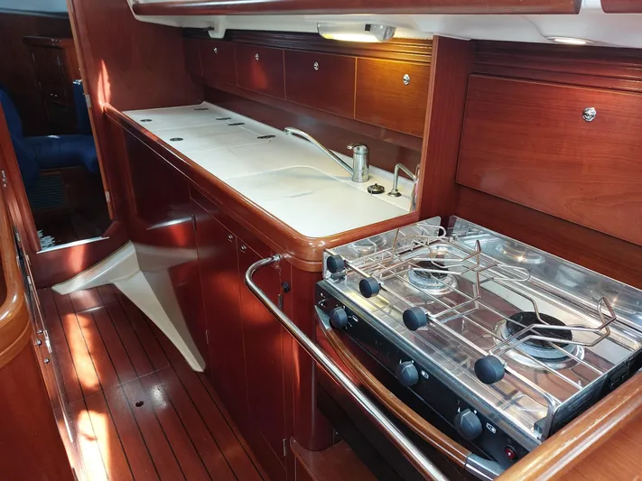 Wind & Wine Yacht Photos Pics Beneteau Oceanis 42CC 2002 yacht kitchen with stove and wooden cabinetry.