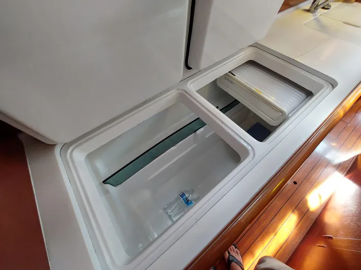 Wind & Wine Yacht Photos Pics Beneteau Oceanis 42CC 2002 yacht interior storage compartments on wooden floor.