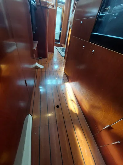 Wind & Wine Yacht Photos Pics Interior view of 2002 Beneteau Oceanis 42CC sailboat with polished wooden flooring.