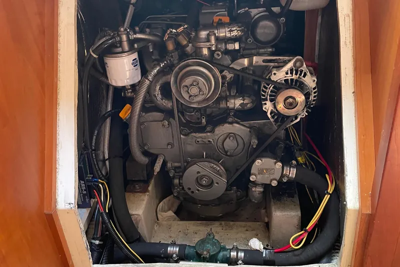 Maeve Yacht Photos Pics Engine compartment of a 2004 Tartan 3700 sailboat, showcasing mechanical components and wiring.