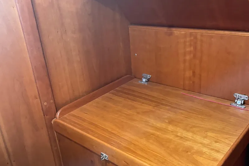 Maeve Yacht Photos Pics Wooden interior of a 2004 Tartan 3700 sailboat, featuring a foldable table.