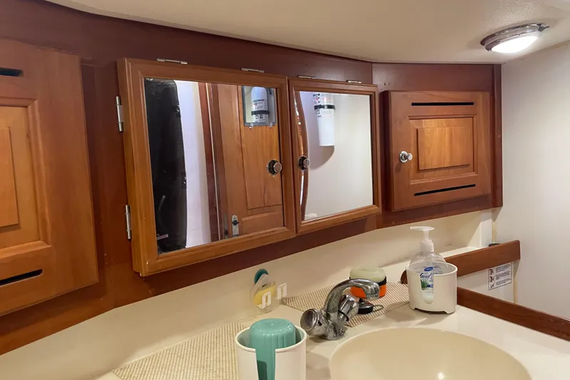 Maeve Yacht Photos Pics Wooden bathroom cabinets and sink in a 2004 Tartan 3700 yacht interior.