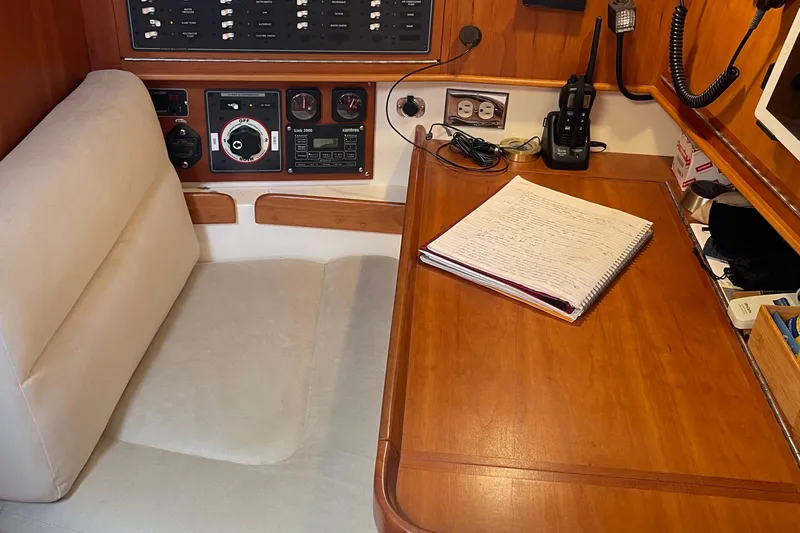 Maeve Yacht Photos Pics Navigation station in 2004 Tartan 3700 sailboat with control panel and notebook.
