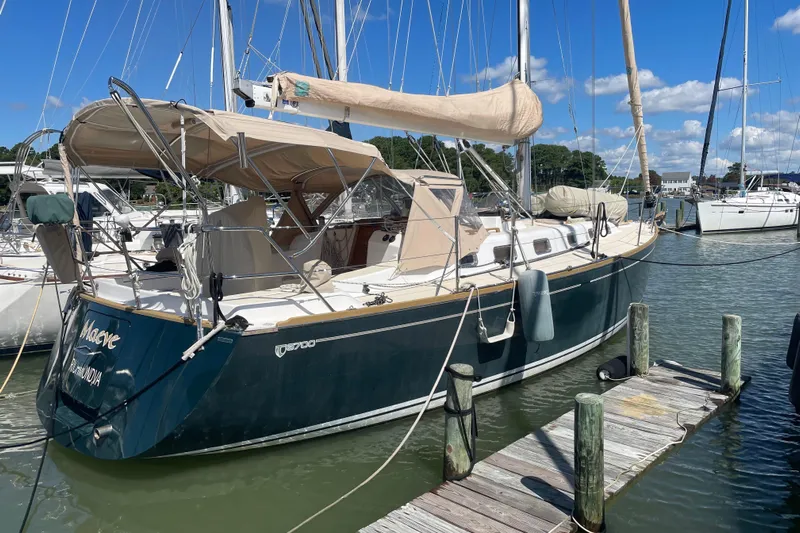 Maeve Yacht Photos Pics Sailboat Tartan 3700, 2004 model, docked at marina under clear blue sky.