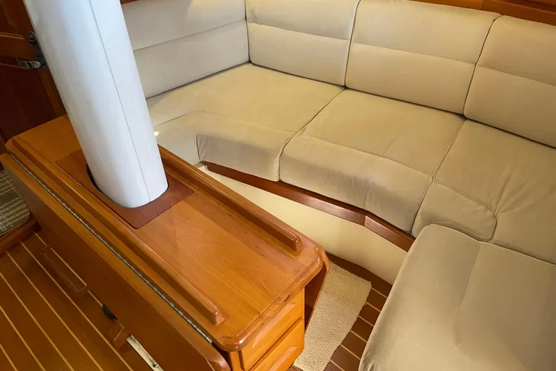 Maeve Yacht Photos Pics Interior of 2004 Tartan 3700 sailboat with beige cushioned seating and wooden accents.