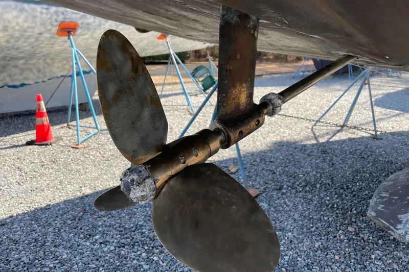 Maeve Yacht Photos Pics Propeller of 2004 Tartan 3700 sailboat on gravel with stands and traffic cone.