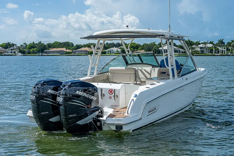  Yacht Photos Pics 2018 Boston Whaler 270 Vantage boat with twin Mercury engines on a calm lake.