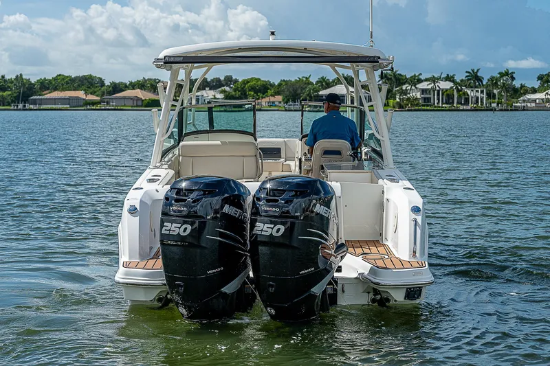 Yacht Photos Pics 2018 Boston Whaler 270 Vantage boat with dual 250 engines on a calm lake.