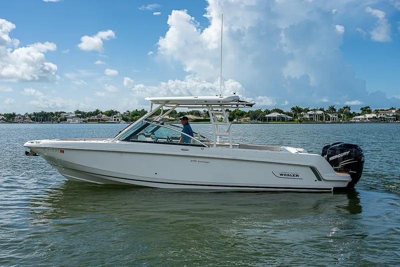  Yacht Photos Pics 2018 Boston Whaler 270 Vantage boat on calm water, clear sky background.