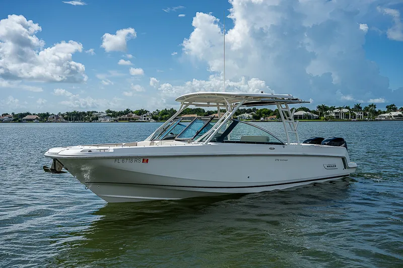  Yacht Photos Pics 2018 Boston Whaler 270 Vantage boat on calm water under blue sky.