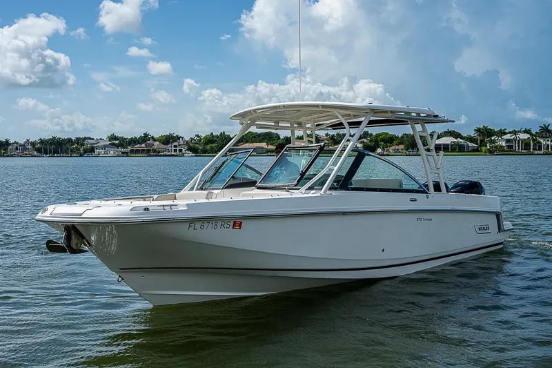  Yacht Photos Pics 2018 Boston Whaler 270 Vantage boat on calm water under a blue sky.