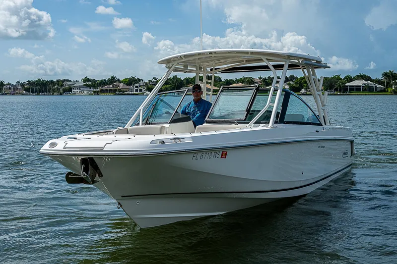  Yacht Photos Pics 2018 Boston Whaler 270 Vantage boat cruising on a sunny lake.
