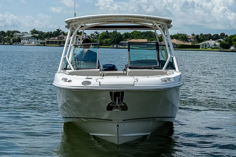  Yacht Photos Pics 2018 Boston Whaler 270 Vantage boat on calm water, front view.