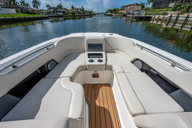  Yacht Photos Pics 2018 Boston Whaler 270 Vantage boat interior with cushioned seating and wooden deck.