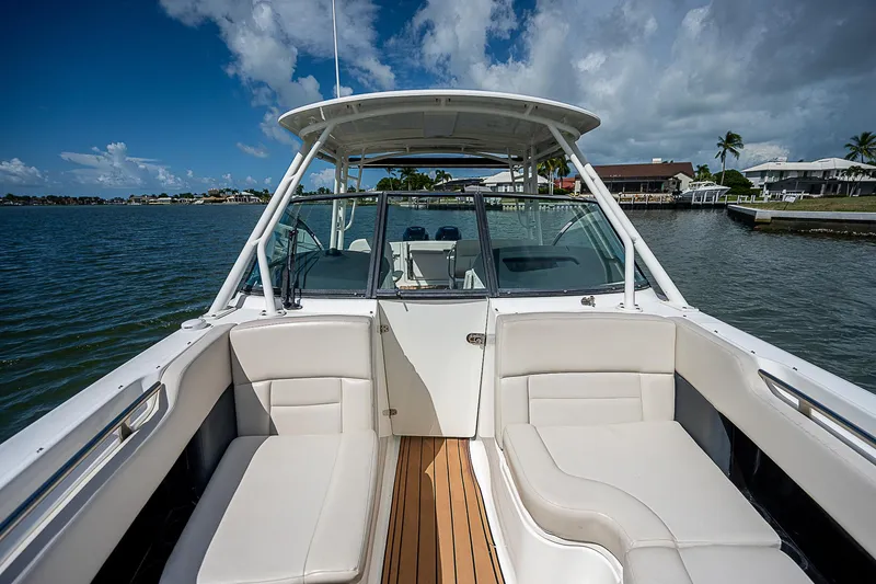  Yacht Photos Pics 2018 Boston Whaler 270 Vantage boat interior with seating, on a sunny day by the water.