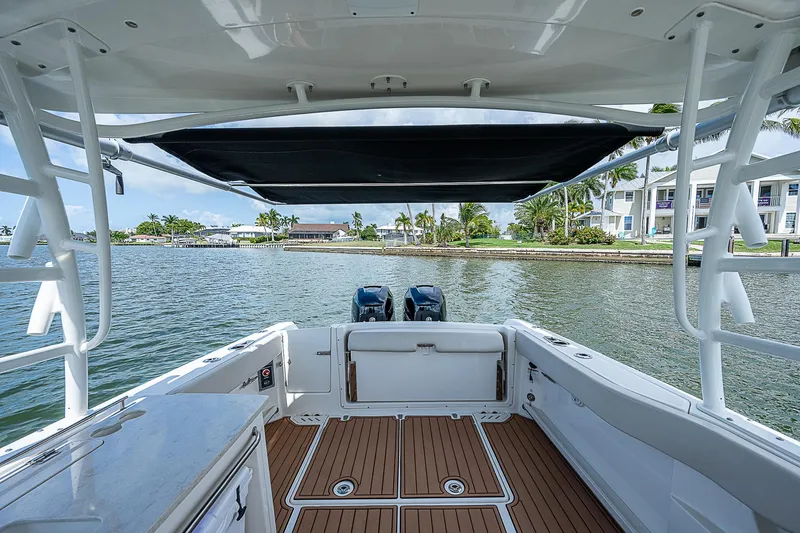  Yacht Photos Pics 2018 Boston Whaler 270 Vantage boat with dual engines, docked by waterfront homes.