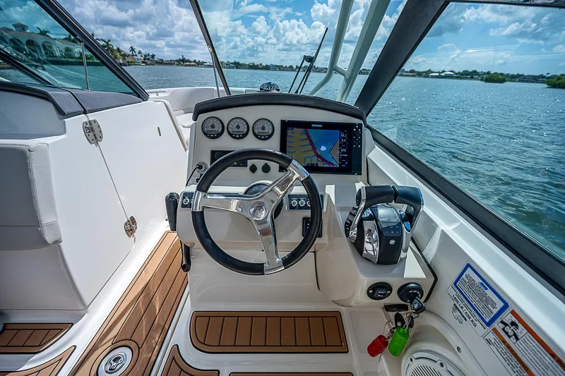  Yacht Photos Pics 2018 Boston Whaler 270 Vantage boat cockpit with steering wheel and navigation system.