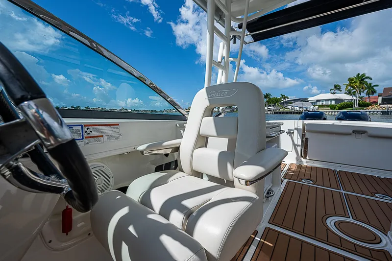  Yacht Photos Pics 2018 Boston Whaler 270 Vantage boat interior with white seating and wooden deck.