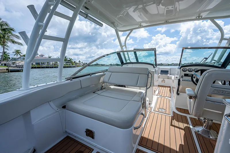  Yacht Photos Pics 2018 Boston Whaler 270 Vantage boat interior with seating and helm, on a sunny day.