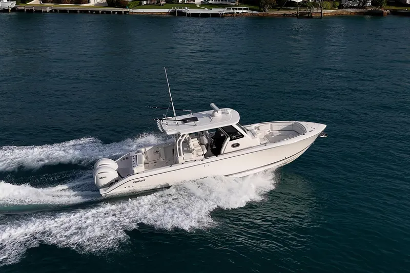 Pigasus Yacht Photos Pics 2024 Pursuit S 328 Sport boat cruising on clear blue water.