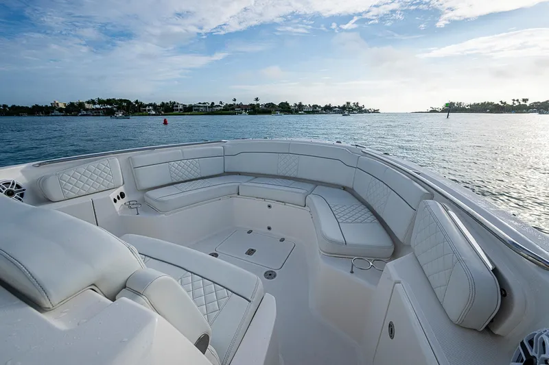 Pigasus Yacht Photos Pics Luxurious seating on 2024 Pursuit S 328 Sport boat, overlooking serene waters.